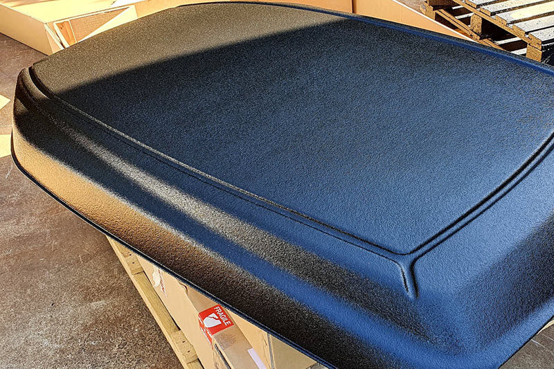 Kubota tractor roof sprayed with LINE-X protective coating.